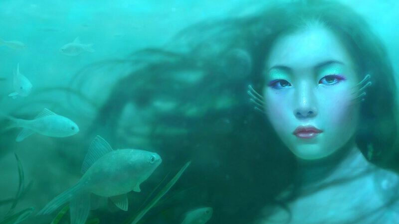 woman underwater with fish