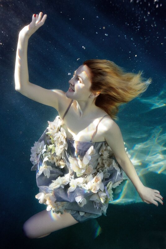 woman underwater with flowers