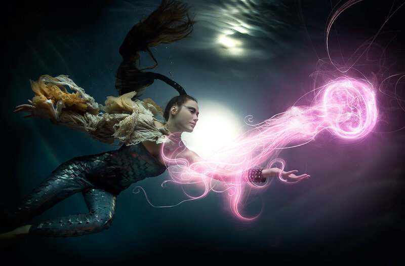 woman underwater with glowing energy