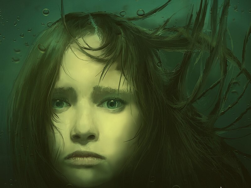 woman underwater with green eyes