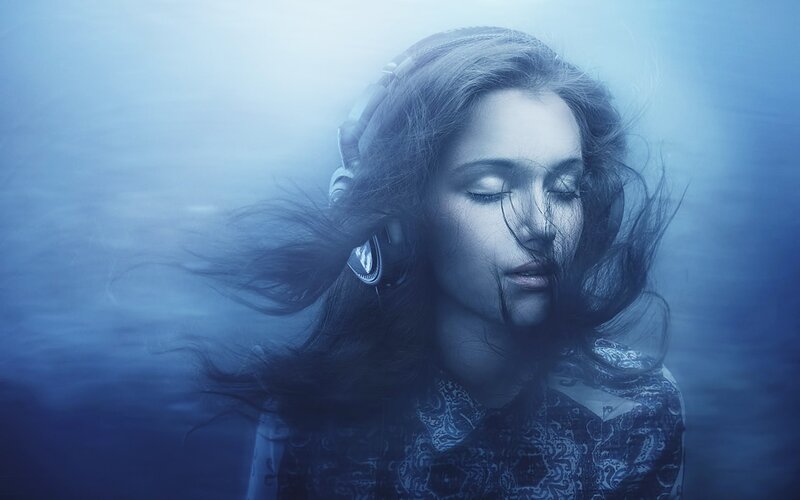 woman underwater with headphones