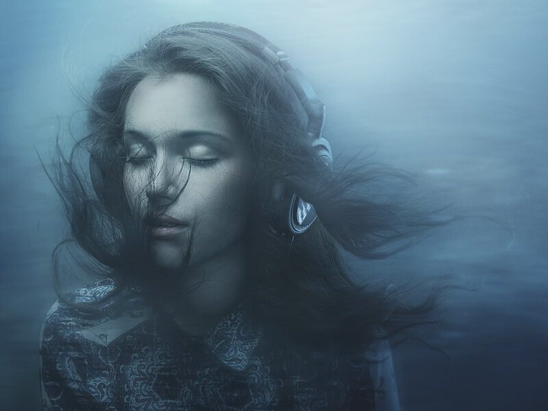 woman underwater with headphones