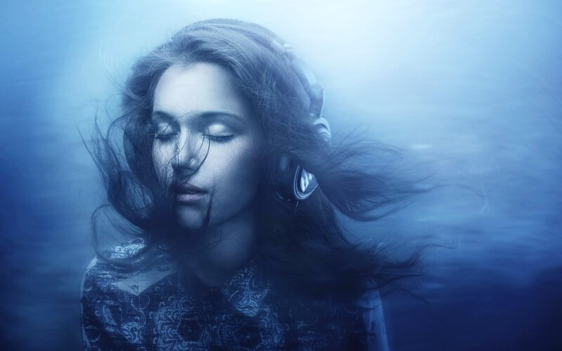 woman underwater with headphones