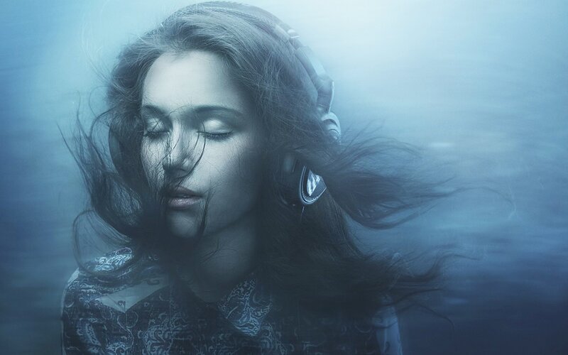 woman underwater with headphones
