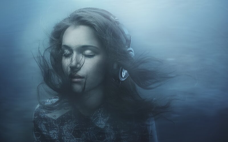 woman underwater with headphones