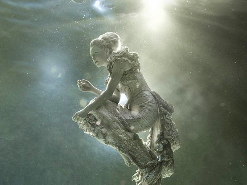 woman underwater with light