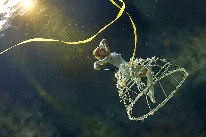 woman underwater with ribbon