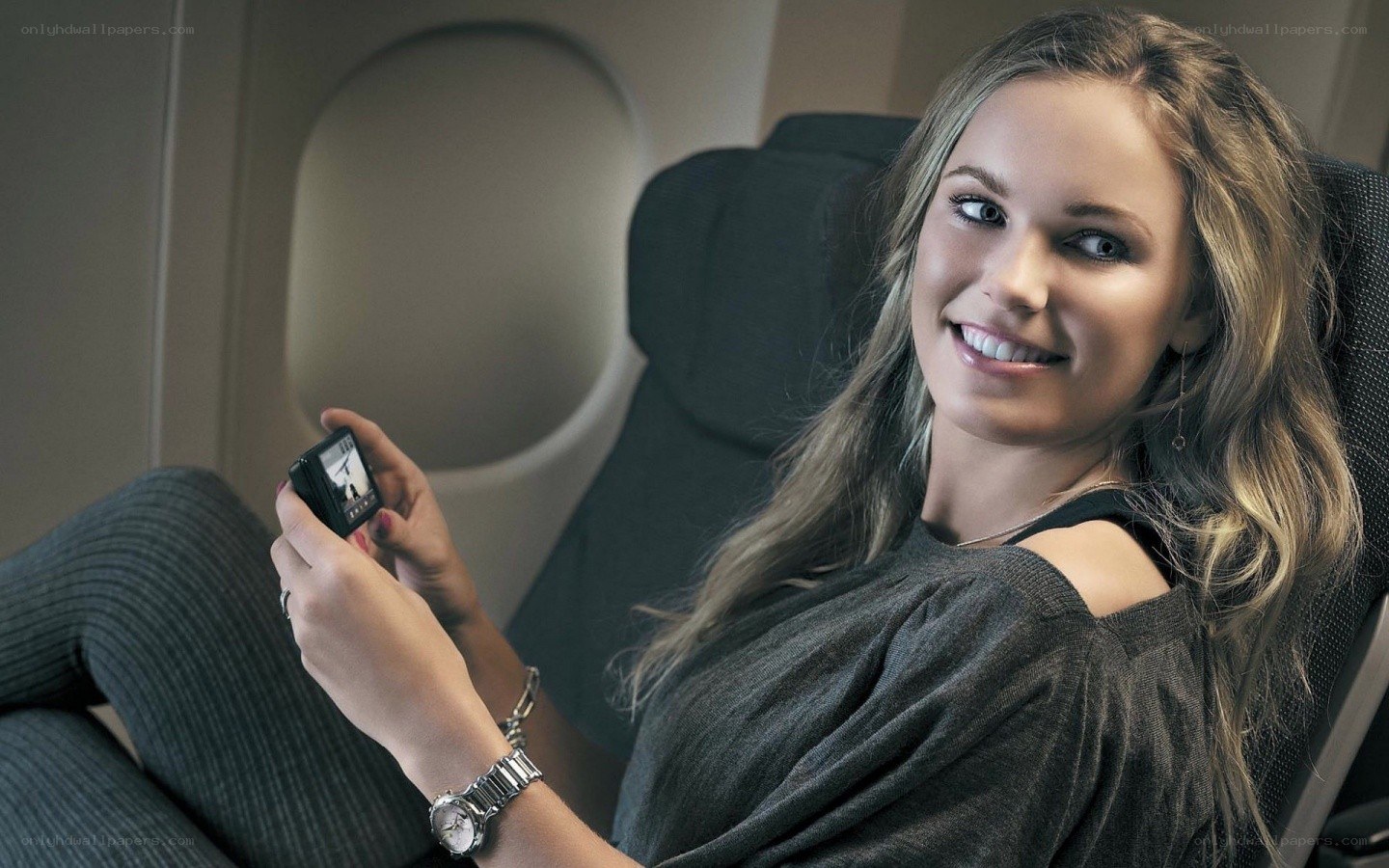 Woman using camera on airplane