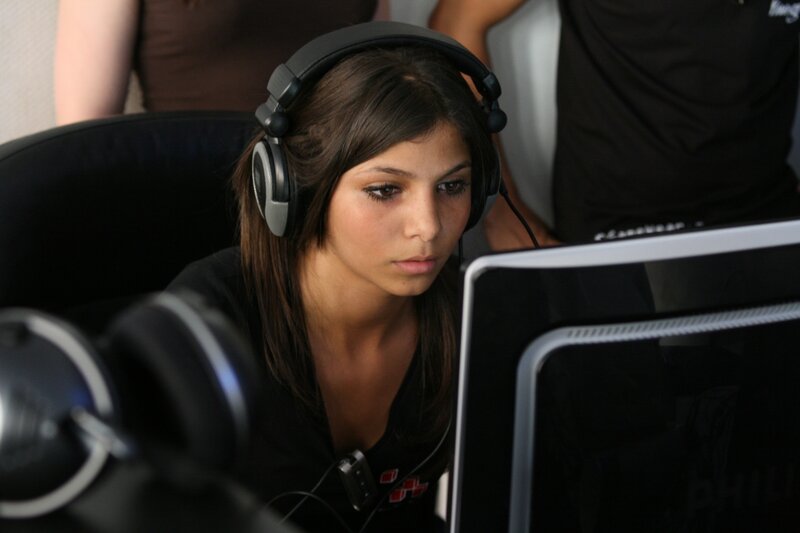woman using computer with headphones