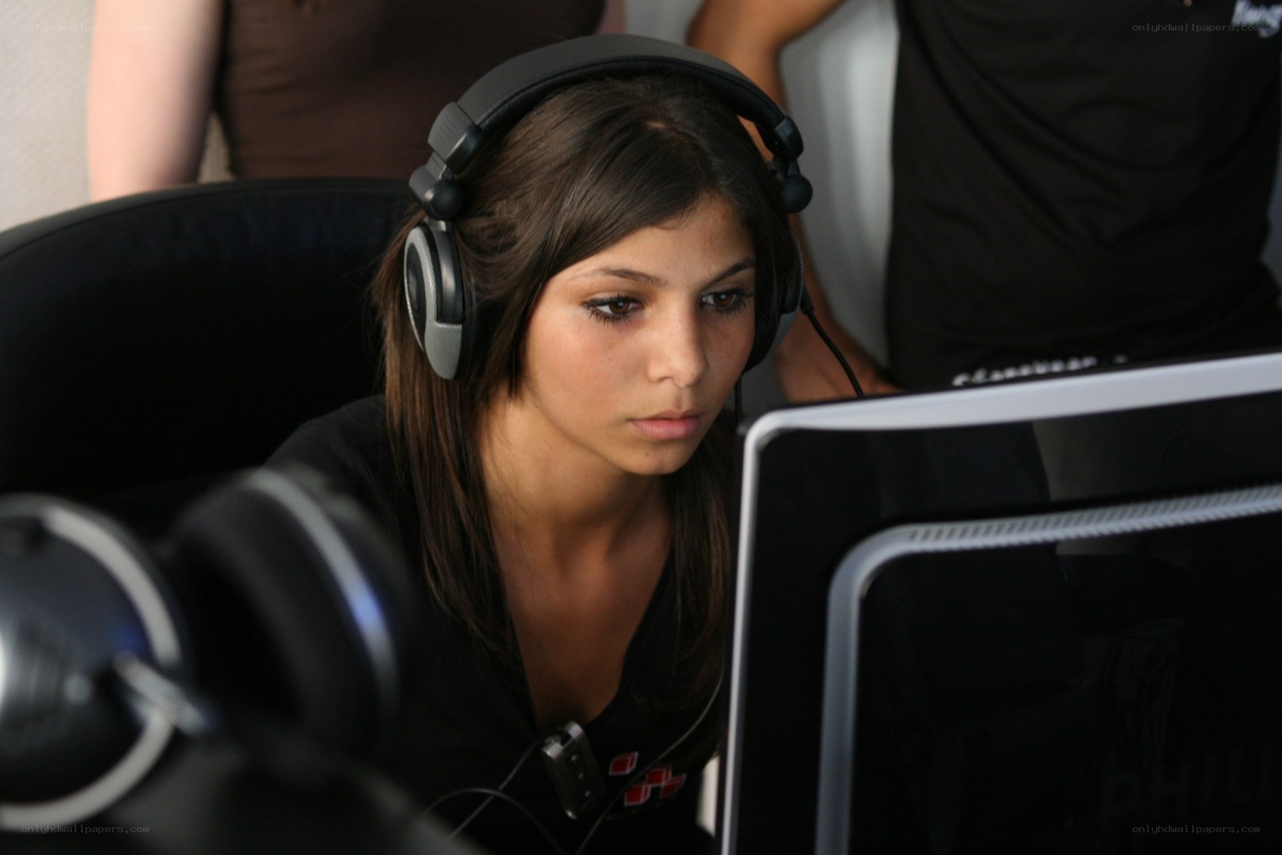 woman using computer with headphones