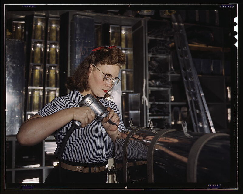 Woman Using Drill in Factory