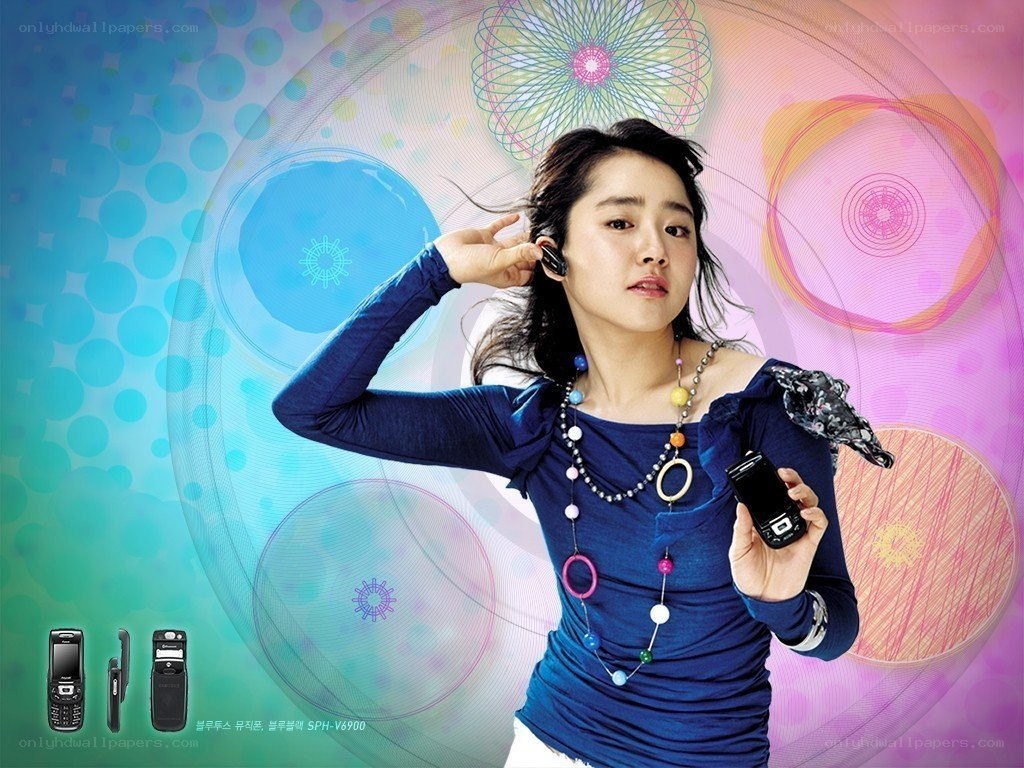 woman using earbud with phone