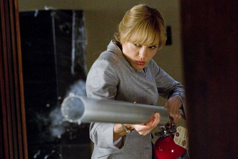 Woman using fire extinguisher