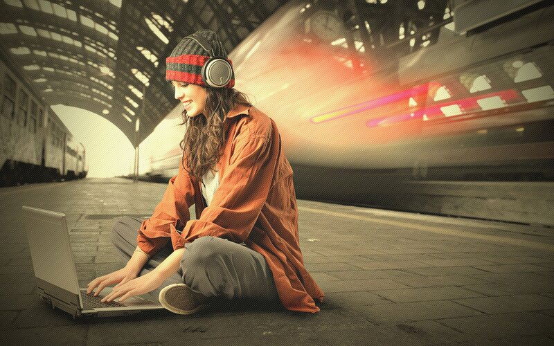 Woman using laptop at train station