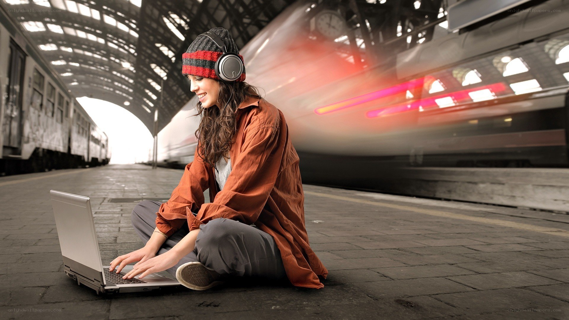 Woman using laptop at train station