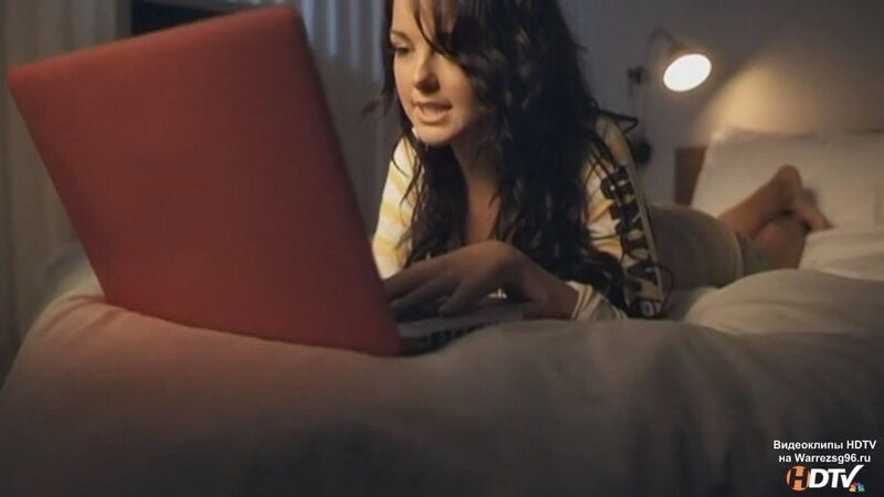 woman using laptop in bed