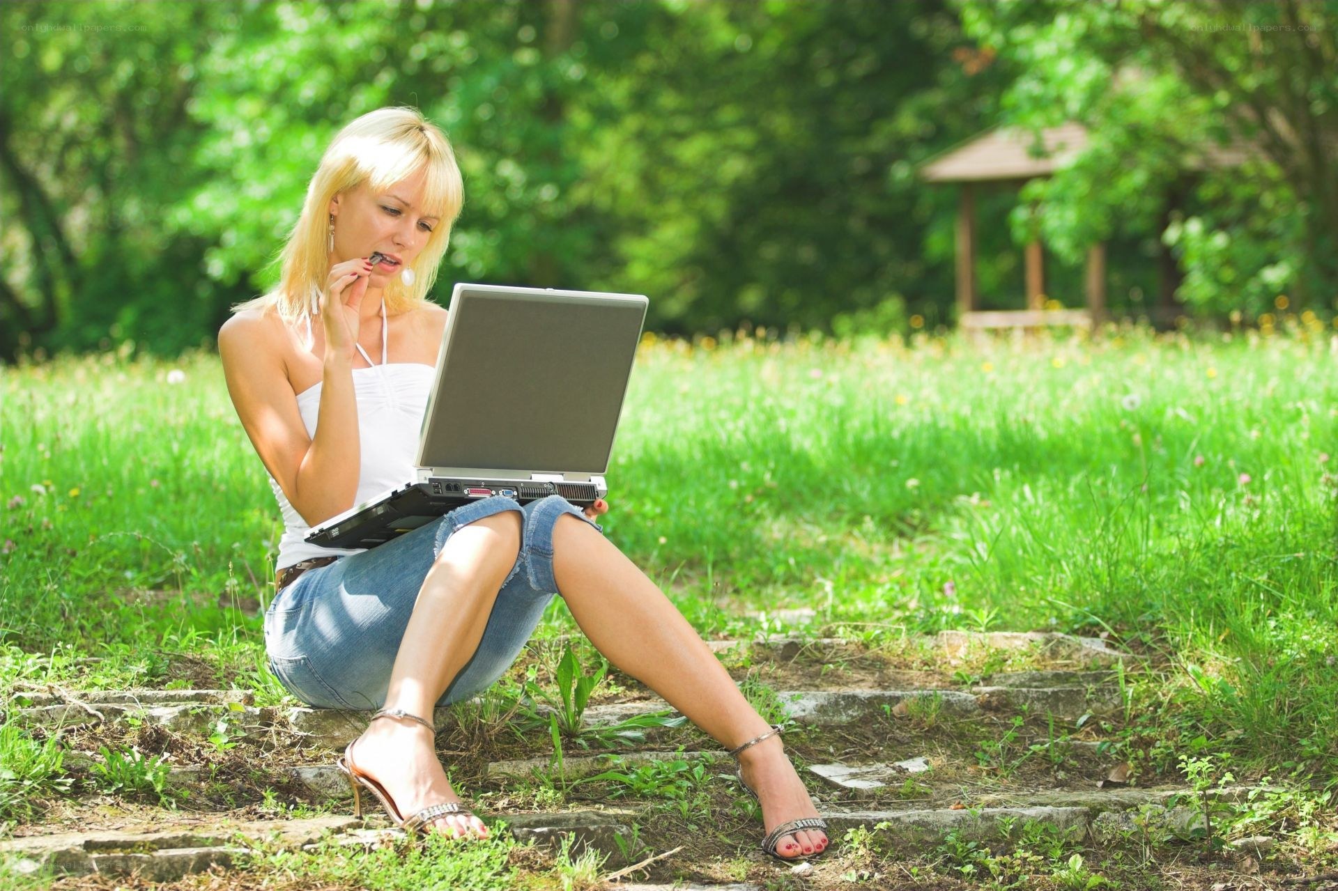 Woman using laptop in park