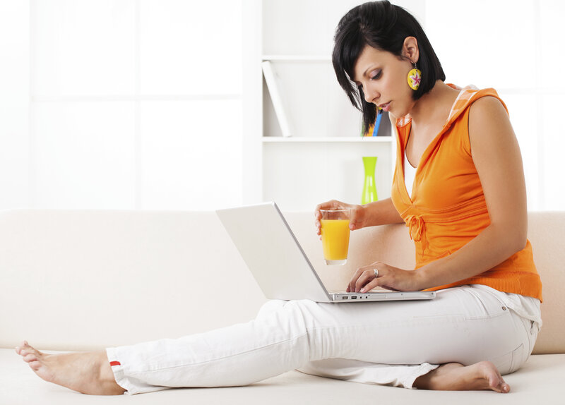 Woman Using Laptop — Orange, Relaxed