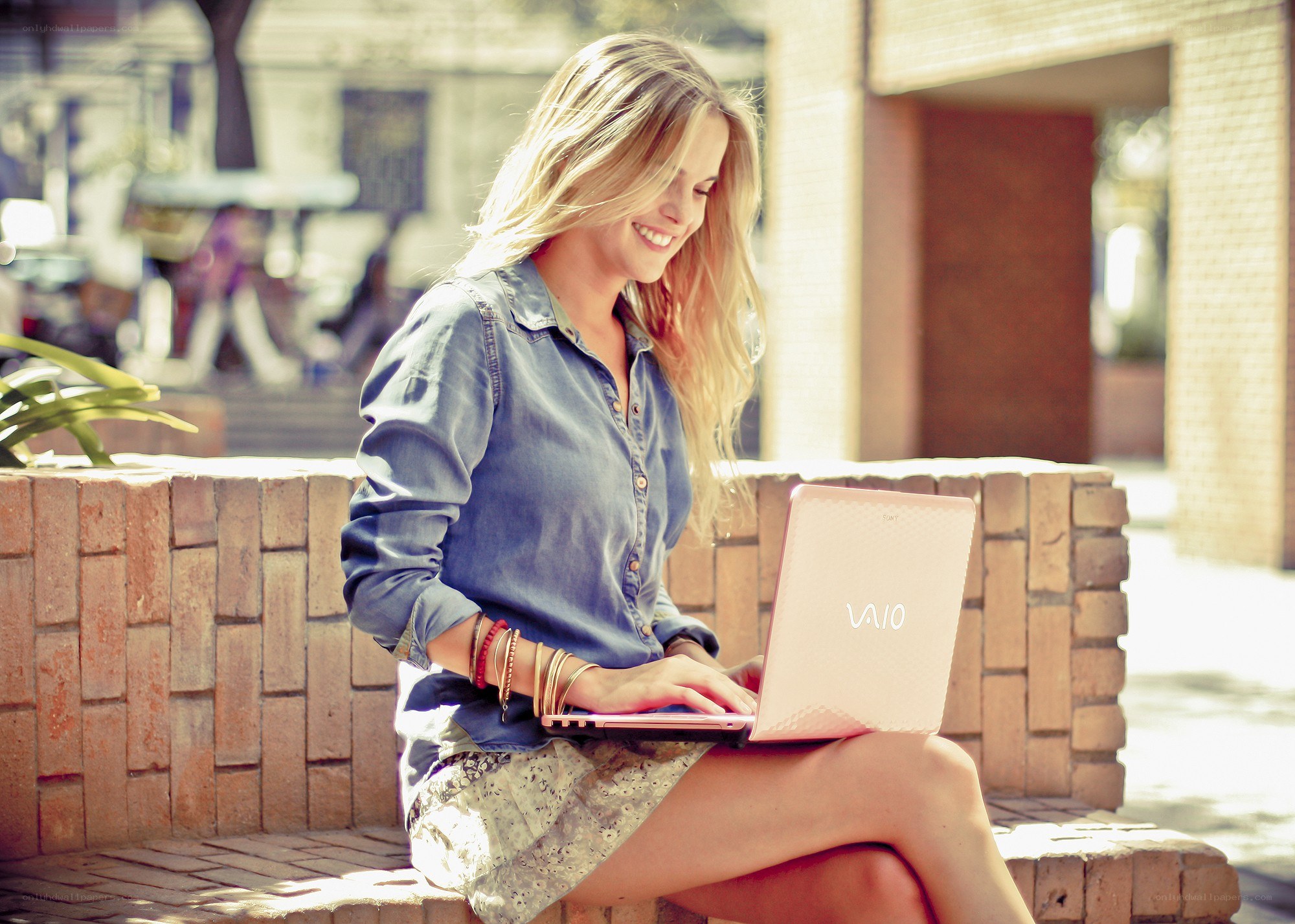 Woman using laptop outdoors