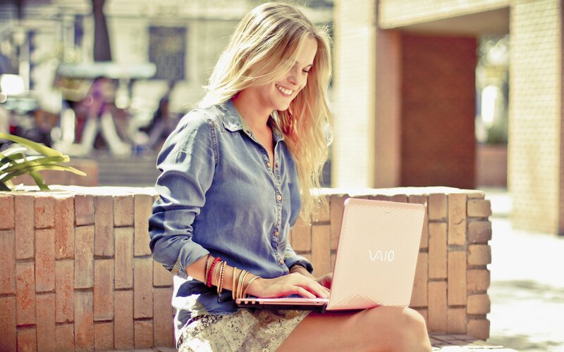 woman using laptop outdoors