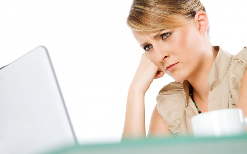 Woman Using Laptop — White, Serious
