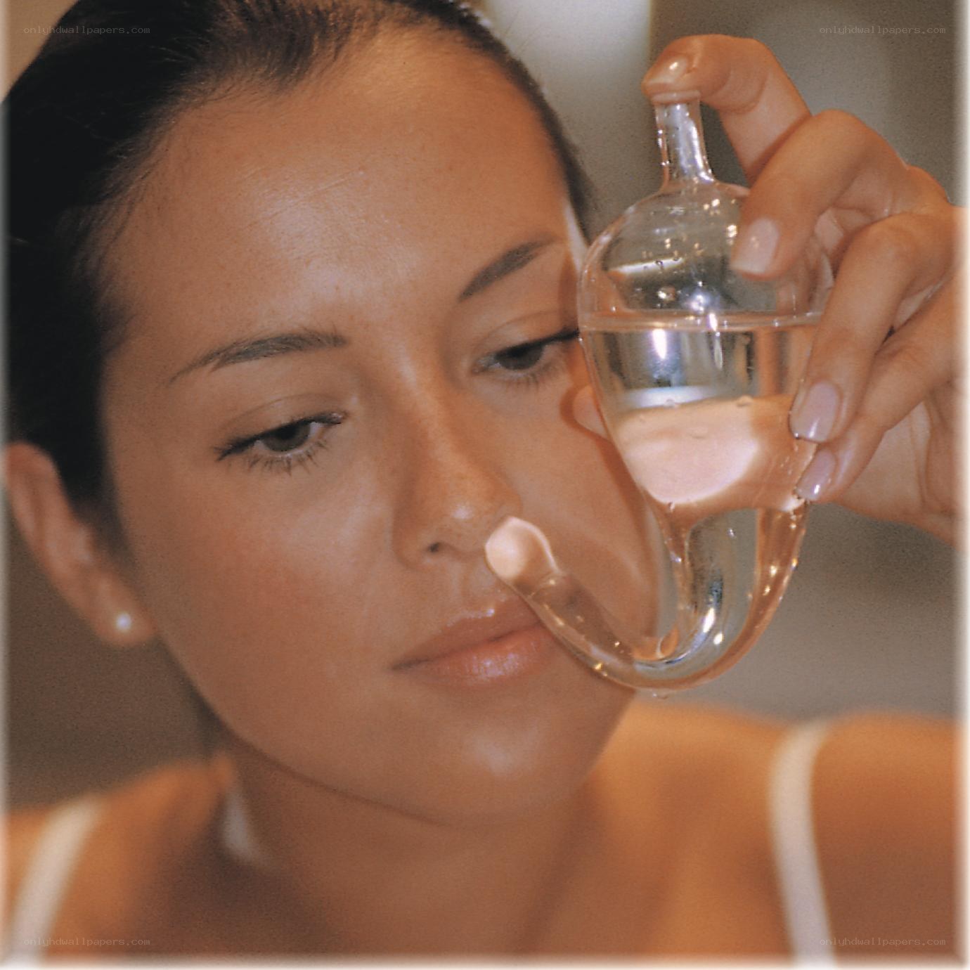 woman using nasal irrigator