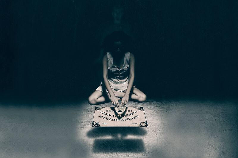 woman using ouija board
