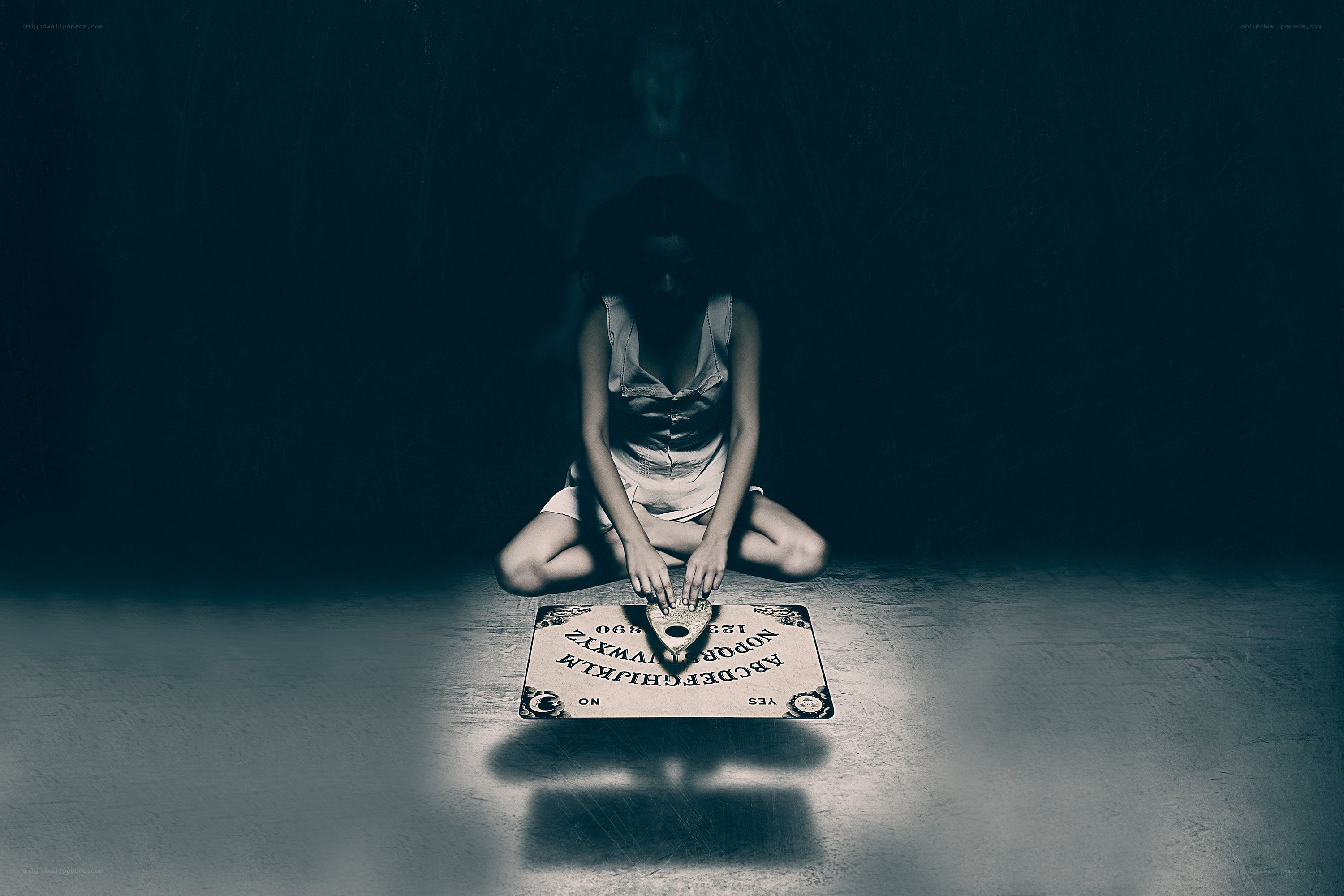 woman using ouija board