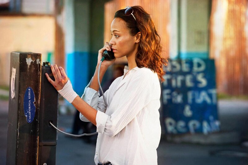 woman using payphone on street