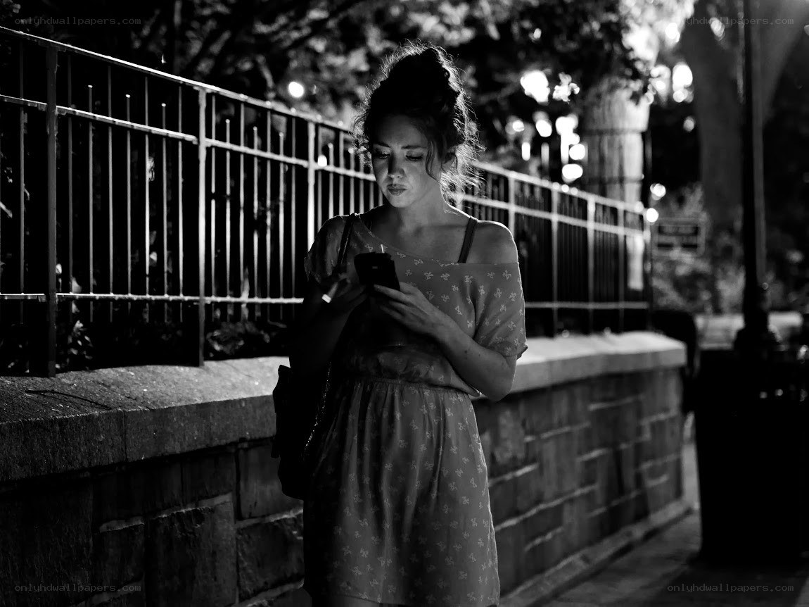 woman using phone at night