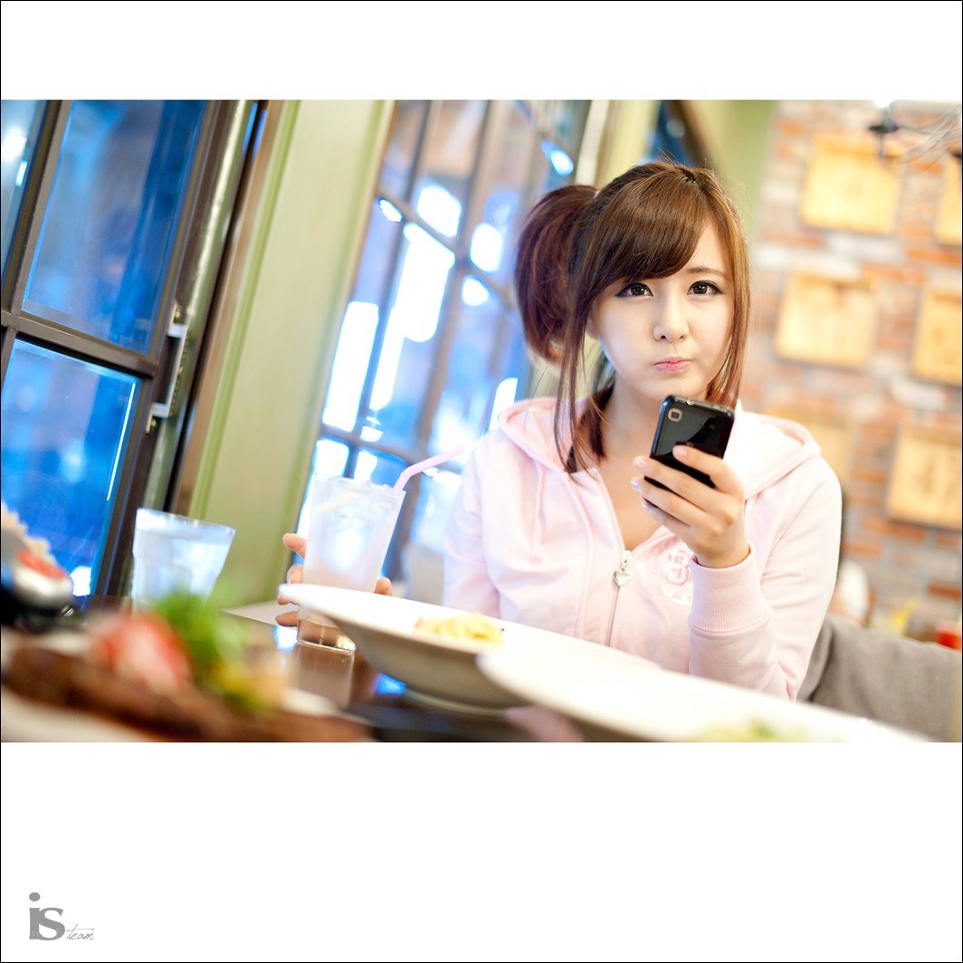 woman using phone at restaurant