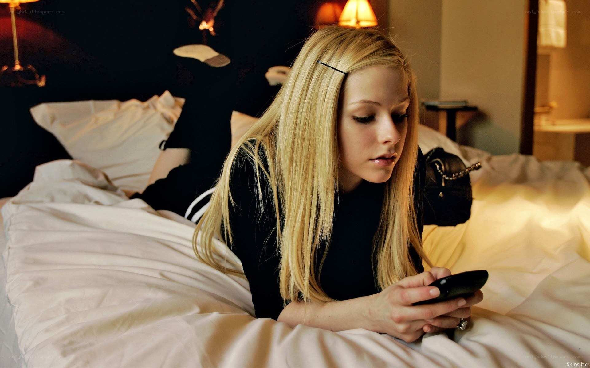woman using phone in bed