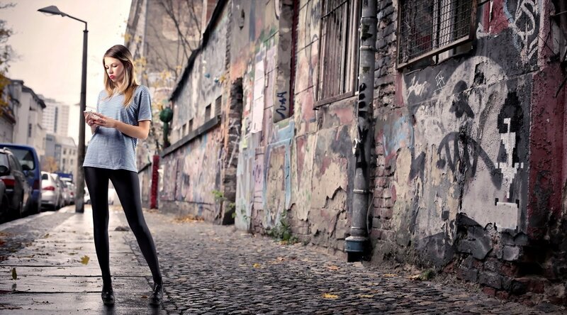 Woman using phone on street