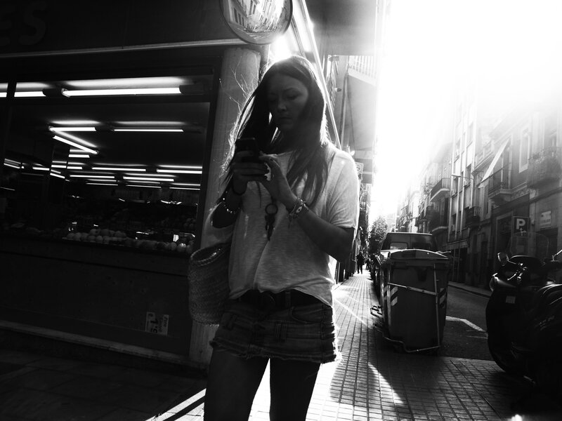 Woman using phone on street