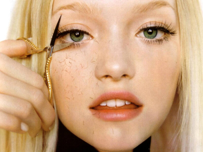 woman using scissors on face