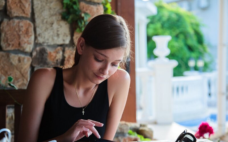 woman using smartphone at outdoor cafe