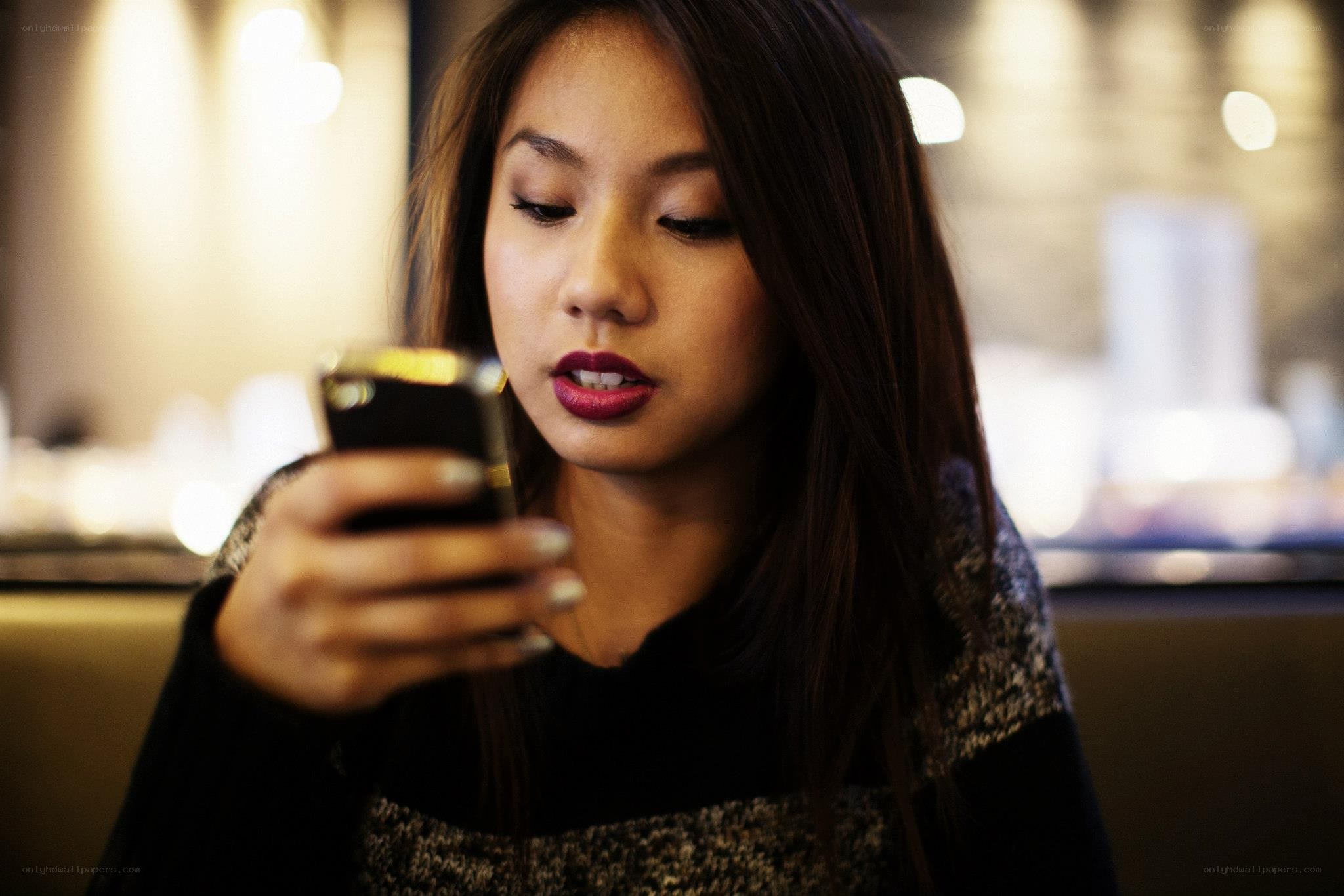 woman using smartphone in cafe