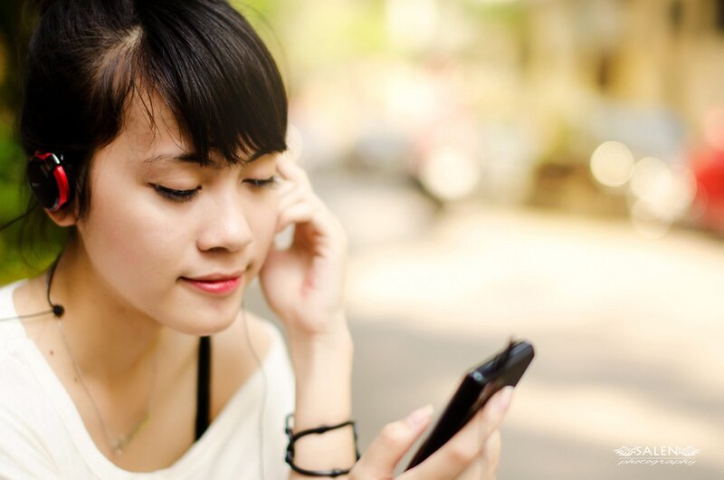 woman using smartphone with headphones