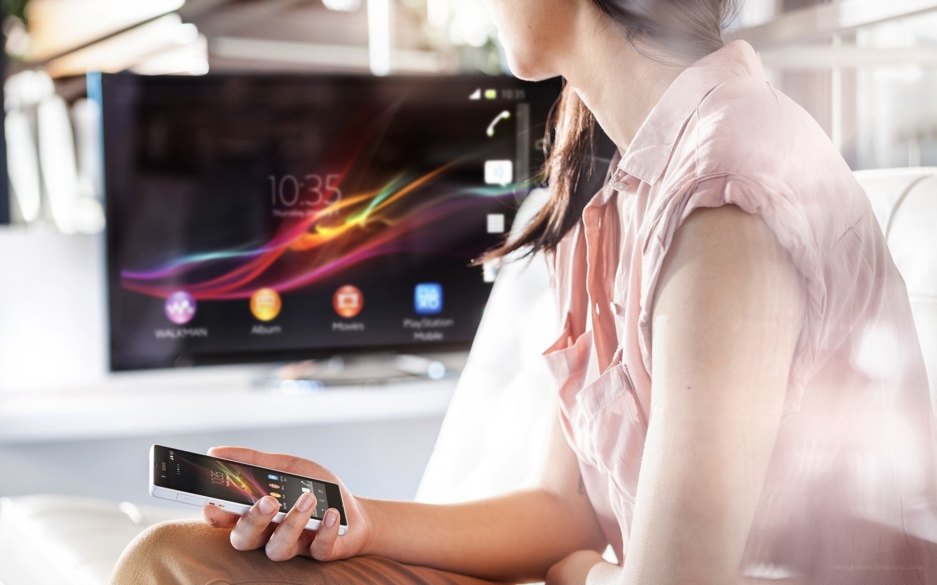 woman using smartphone with TV