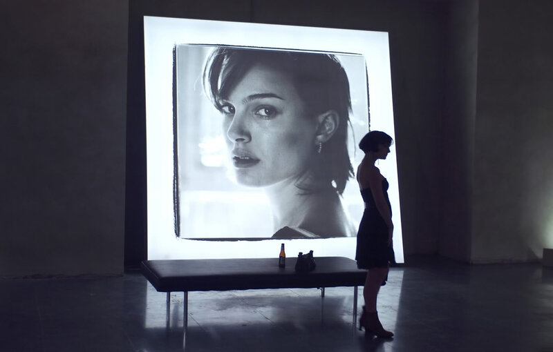 woman viewing large portrait