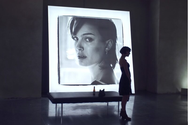 woman viewing large portrait
