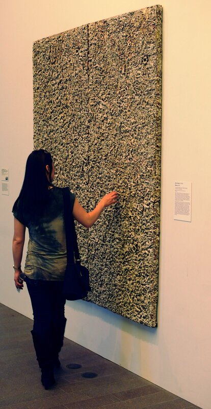 Woman viewing textured art