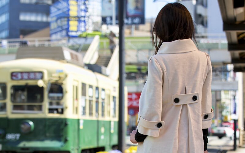 Woman waiting for tram in city