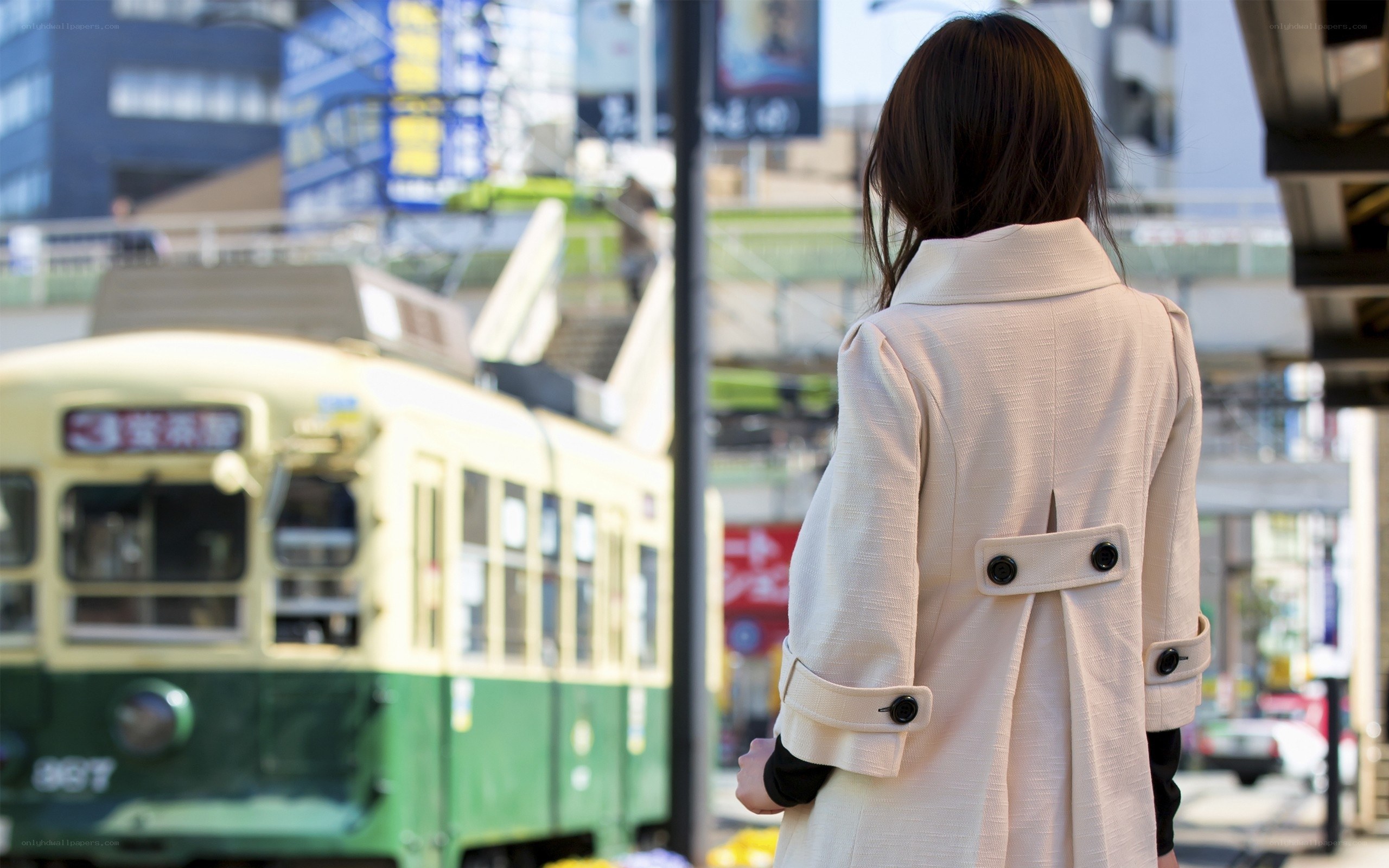 Woman waiting for tram in city