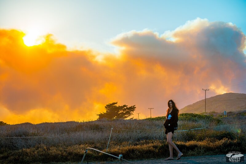 Woman walking at sunset near wildfire