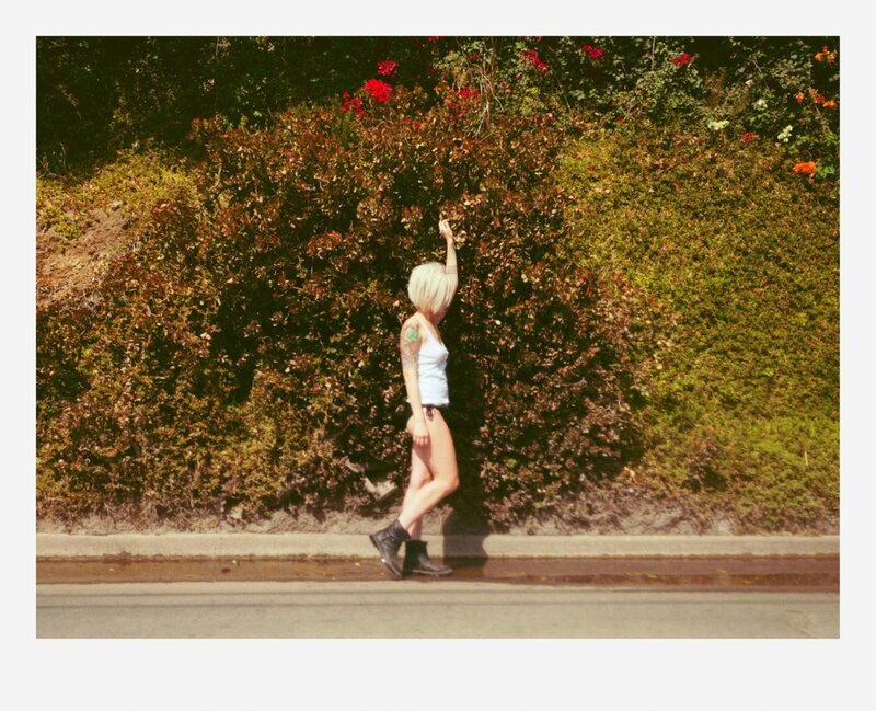 woman walking by bushes