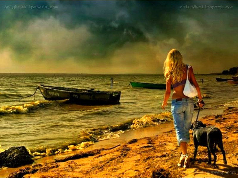 Woman walking dog on beach