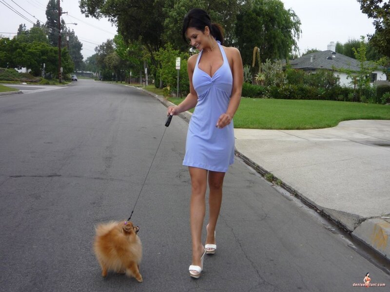 Woman walking dog on street