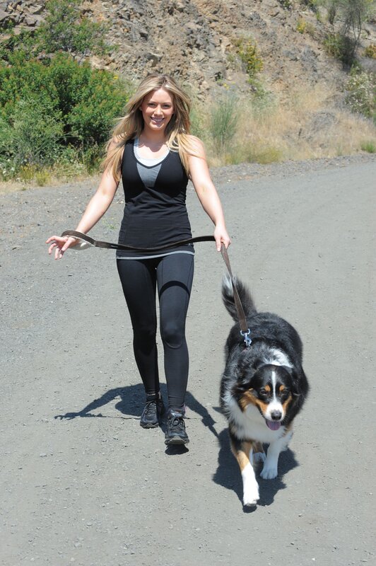 Woman walking dog on trail
