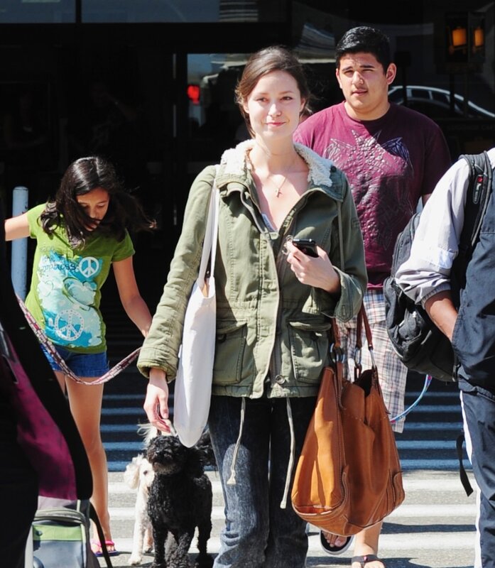 Woman walking dogs on street